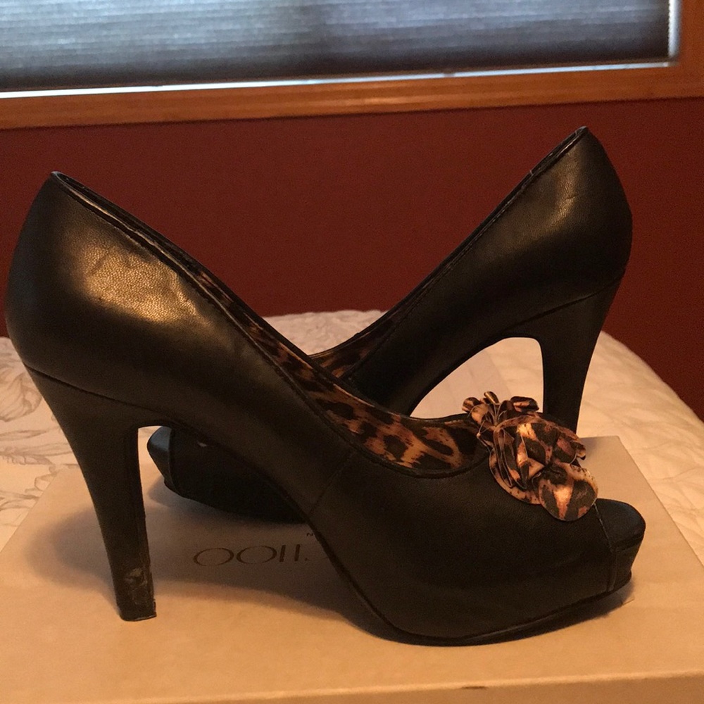 Slightly worn black heels with cheetah flair toe